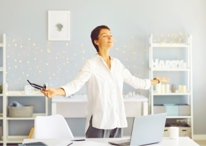 Woman relaxed with arms wide in office setting